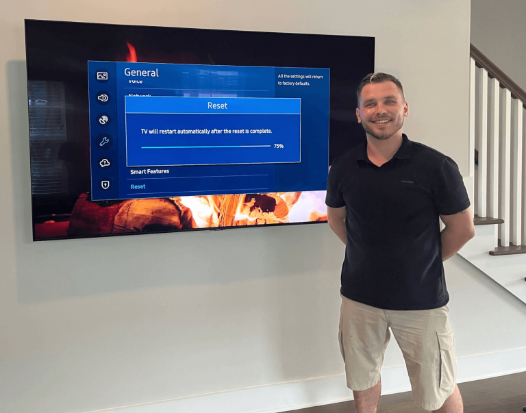 TV wall mount installation with technician resetting Smart TV – Atlanta home